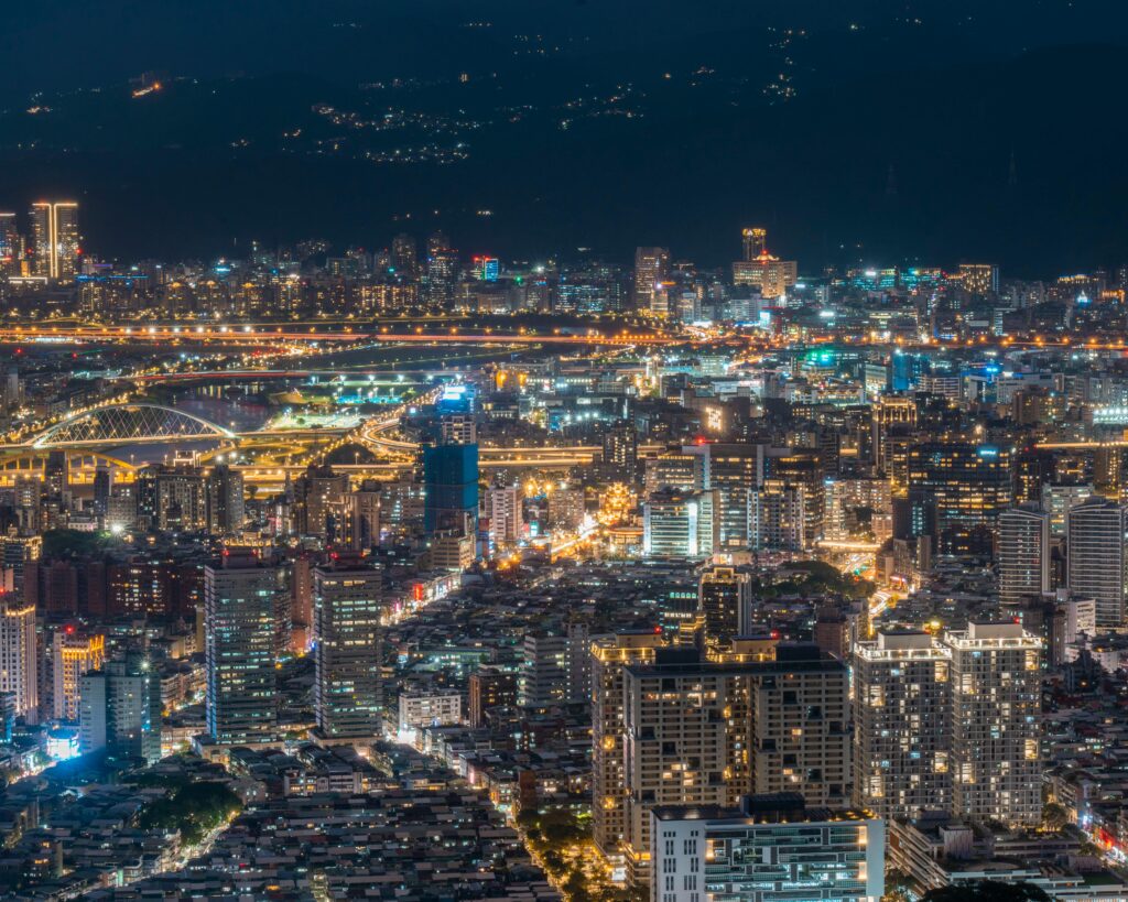 A breathtaking night view of Taipei city showcasing its modern illuminated skyline and architecture.
